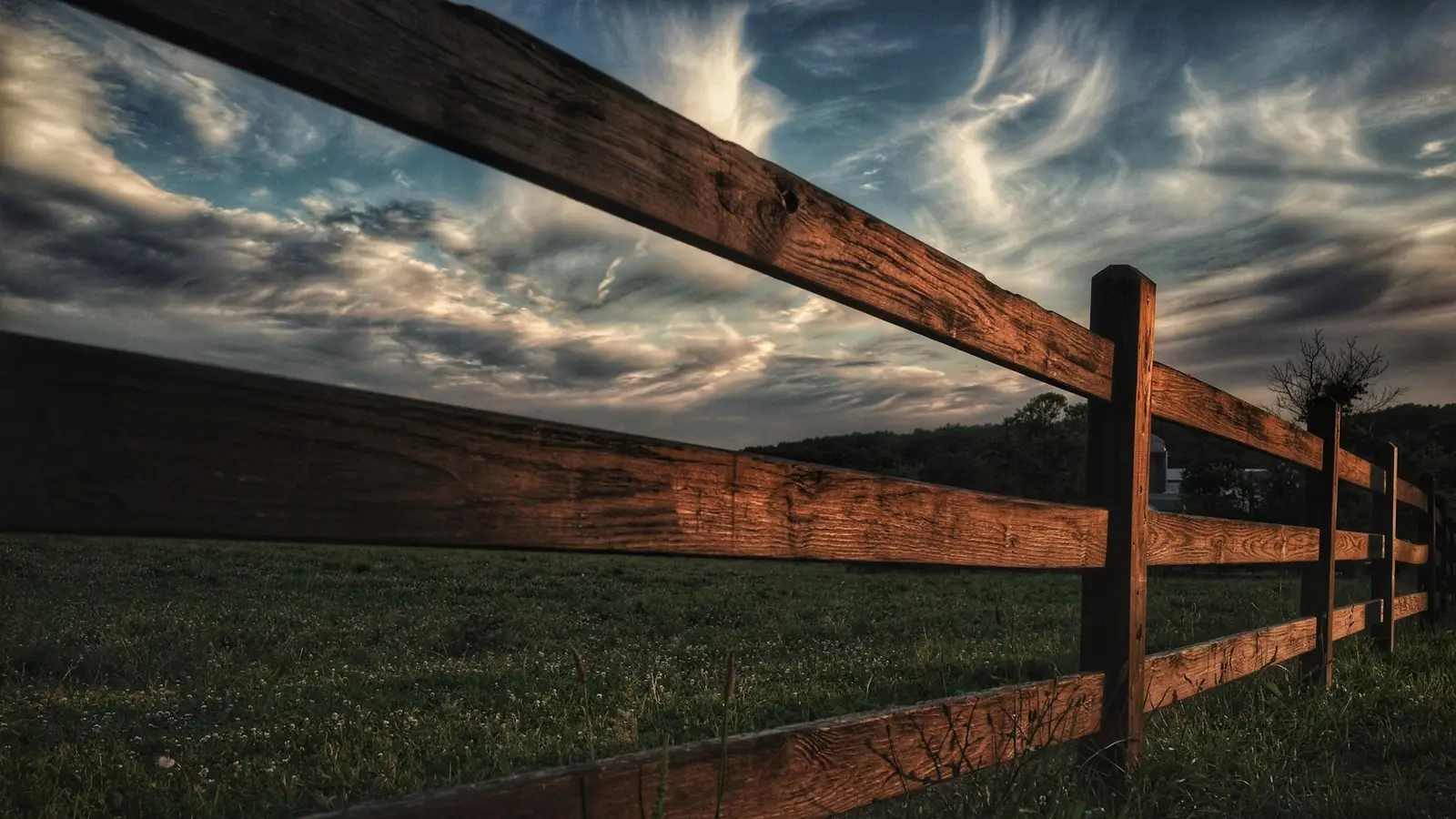 Wooden fence running along a green yard