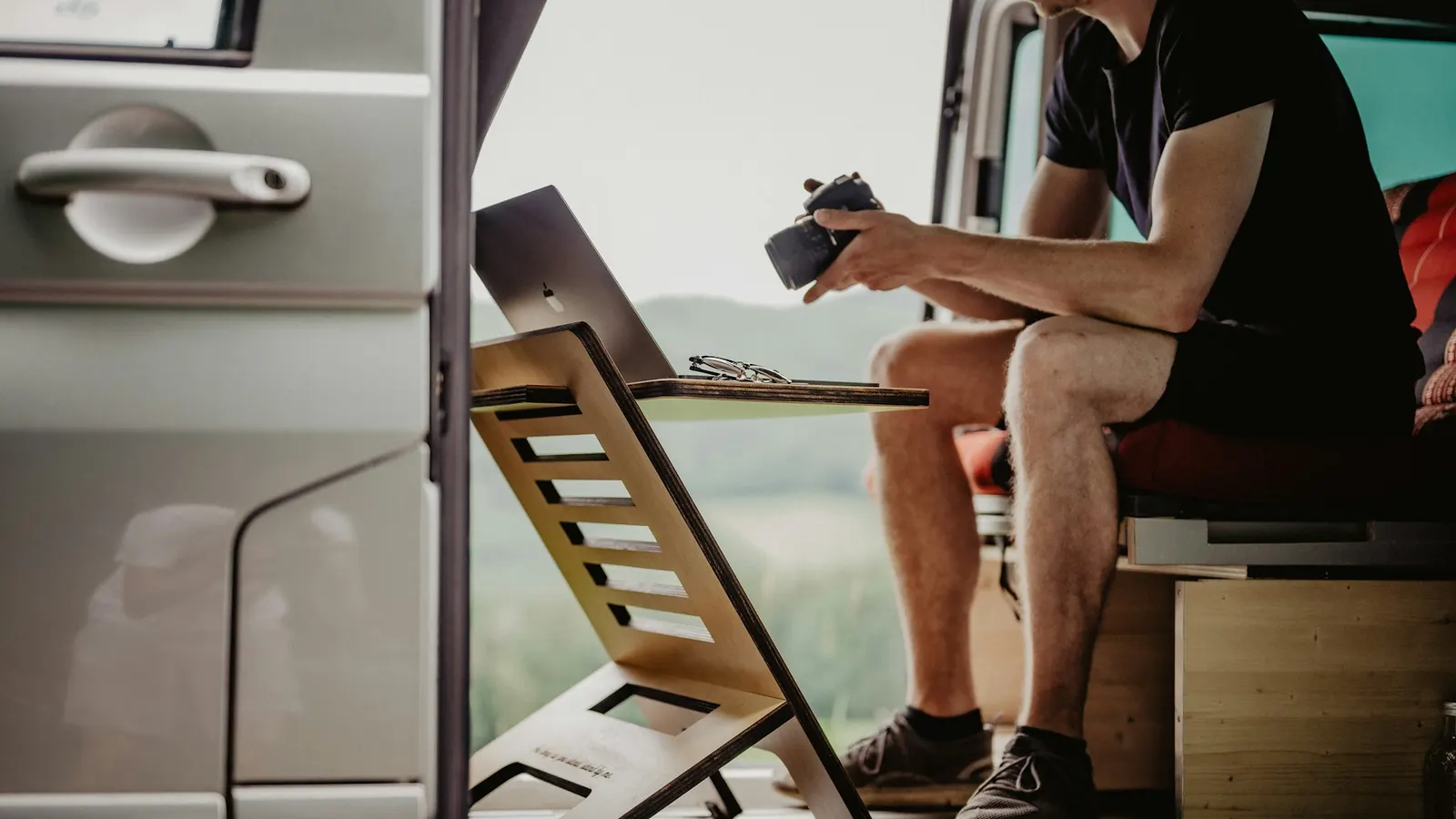 HVAC technician working from the back of his service van, reviewing options on a tablet