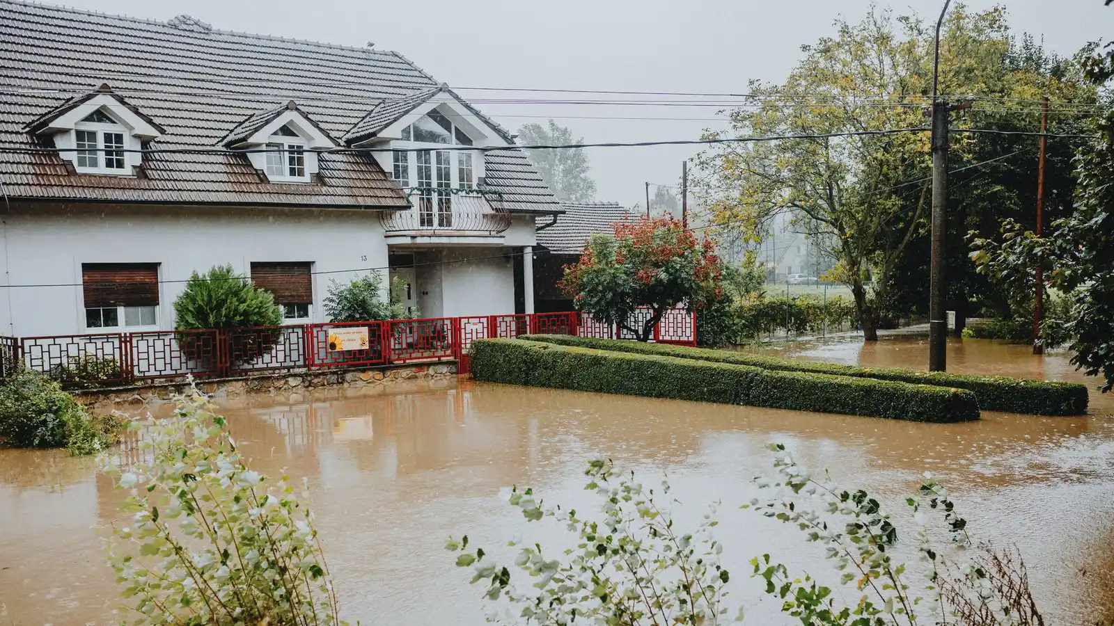 Suburban house surrounded by floodwater after heavy rain