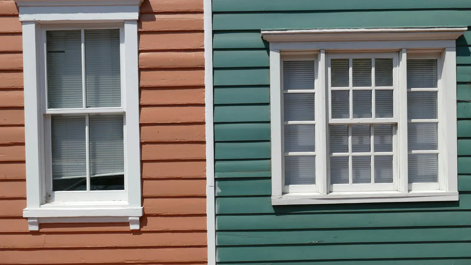 Two neighboring houses with different siding colors