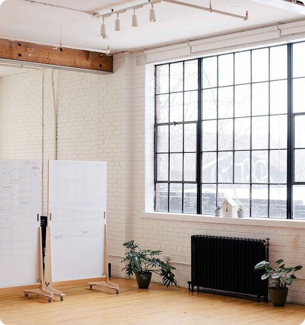 Whiteboard wireframes in a loft studio with industrial windows