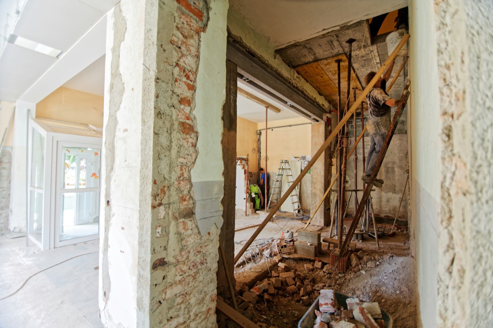 Kitchen renovation in progress with exposed walls and structural work