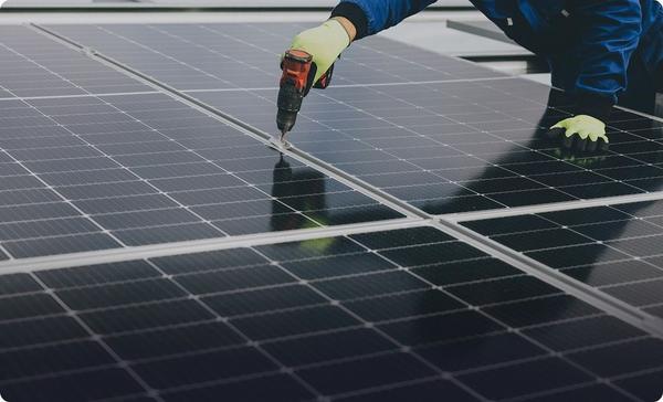 Solar panel installer securing panels on a rooftop