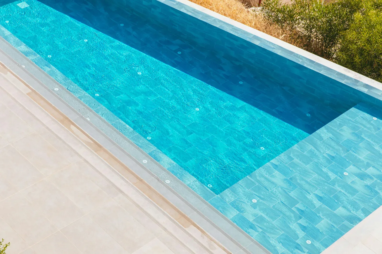 Overhead view of tile and water detail on a finished Tucson pool, the visual portfolio content that ranks