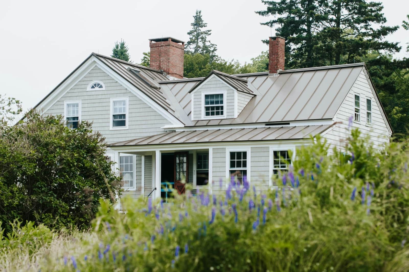 Roofing crew installing shingles on a residential roof during a job
