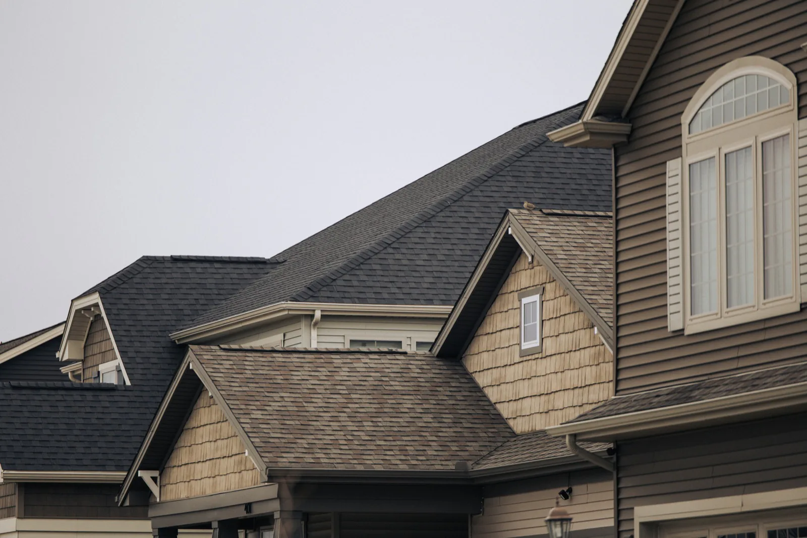 Roofing crew documenting storm damage on a residential pitched roof